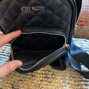 New Black Steve Madden backpack purse. Quilted. Seatbelt straps. 2 zip pockets.